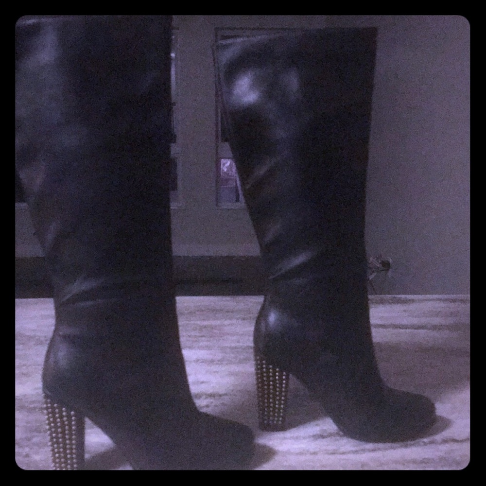Knee length black boots with studded heel